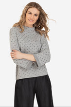 Canadian Designed Grey on Grey Polka dot Print Funnel neck style sweater with a rolled sleeve. Pair this top with a cute denim and wedge boot or fabulous dress pant. Shop deserve jewels